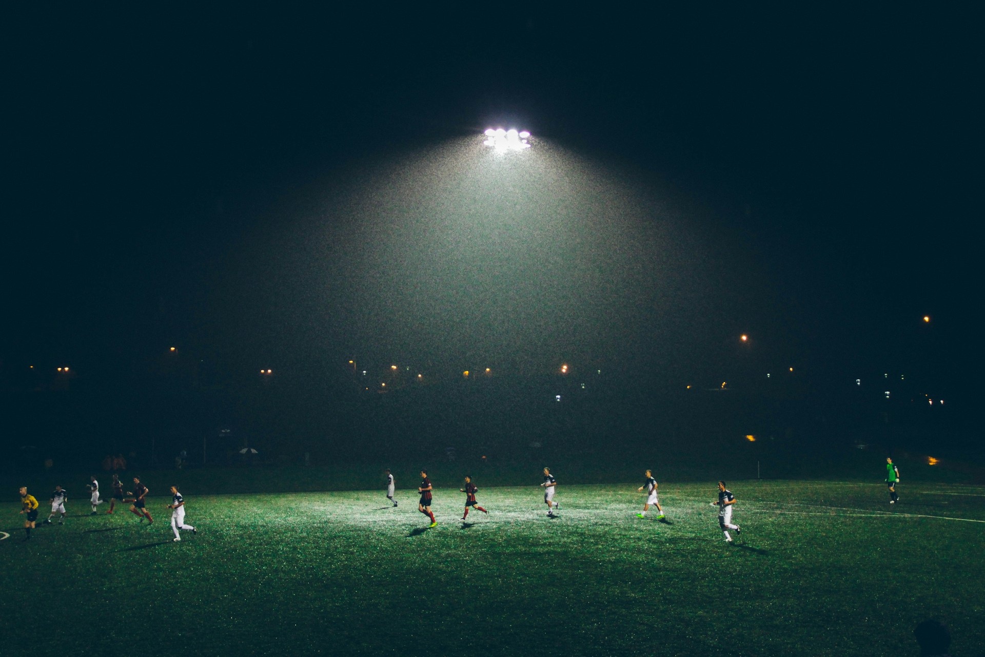 Night training session under stadium floodlights